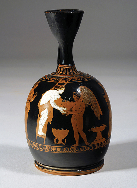 Fig. 3. Athenian red-figure squat lekythos (ca. 390 B.C.E., ht. 14 cm) depicting Eros handing a potted plant to Aphrodite, who is on a ladder. This scene probably alludes to the placement of potted plants on a roof in association with the worship of Adonis. Karlsruhe, Badisches Landesmuseum, inv. no. B39 (courtesy Badisches Landesmuseum).